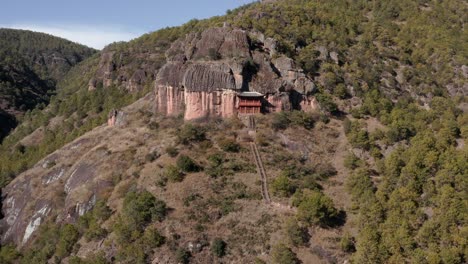 buddhist monastery on chinese mountain cliffside, yunnan china, aerial view