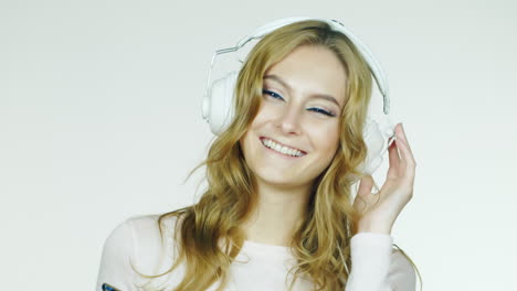 Attractive-Woman-Dancing-And-Listening-To-Music-Video-Shot-In-The-Studio-On-A-White-Background-Hd-Vi