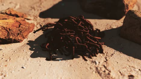 old-rusted-abandoned-chain-on-sand-beach