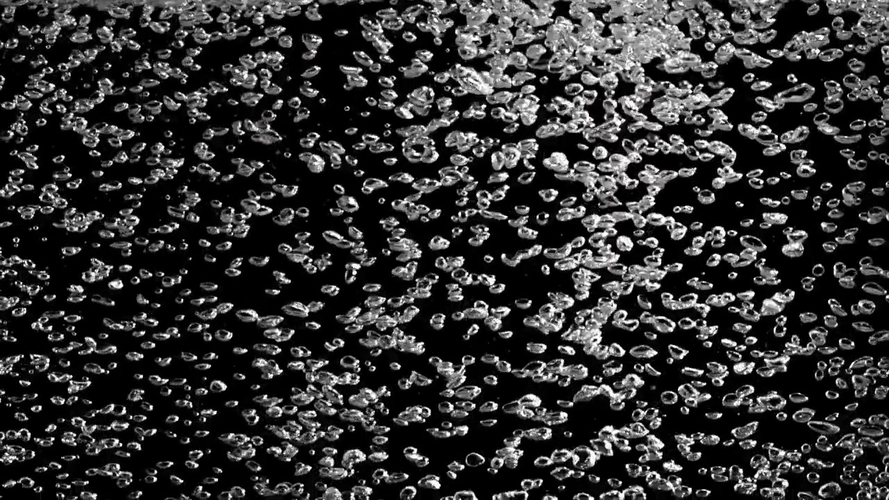 Clear Air Bubbles Rising on a Black Background