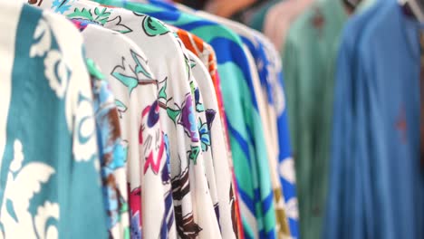 colorful floral shirts on hangers in a clothing boutique