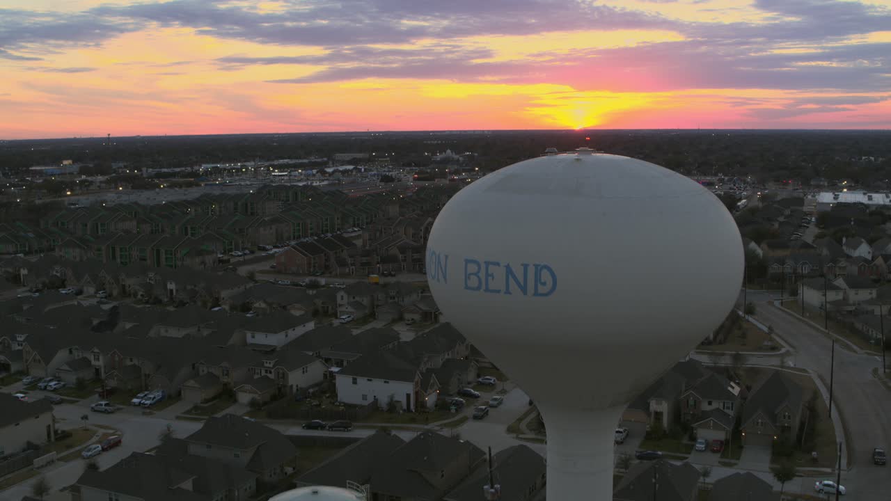 Smooth aerial drone footage of the Mission Bend residential neighborhood in west Houston, Texas, showing suburban homes and community layout in daylight. Suitable for real estate projects