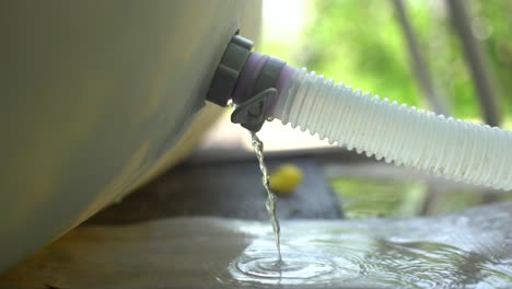 Blue-plastic-hose-for-cleaning-a-swimming-pool,-Close-up