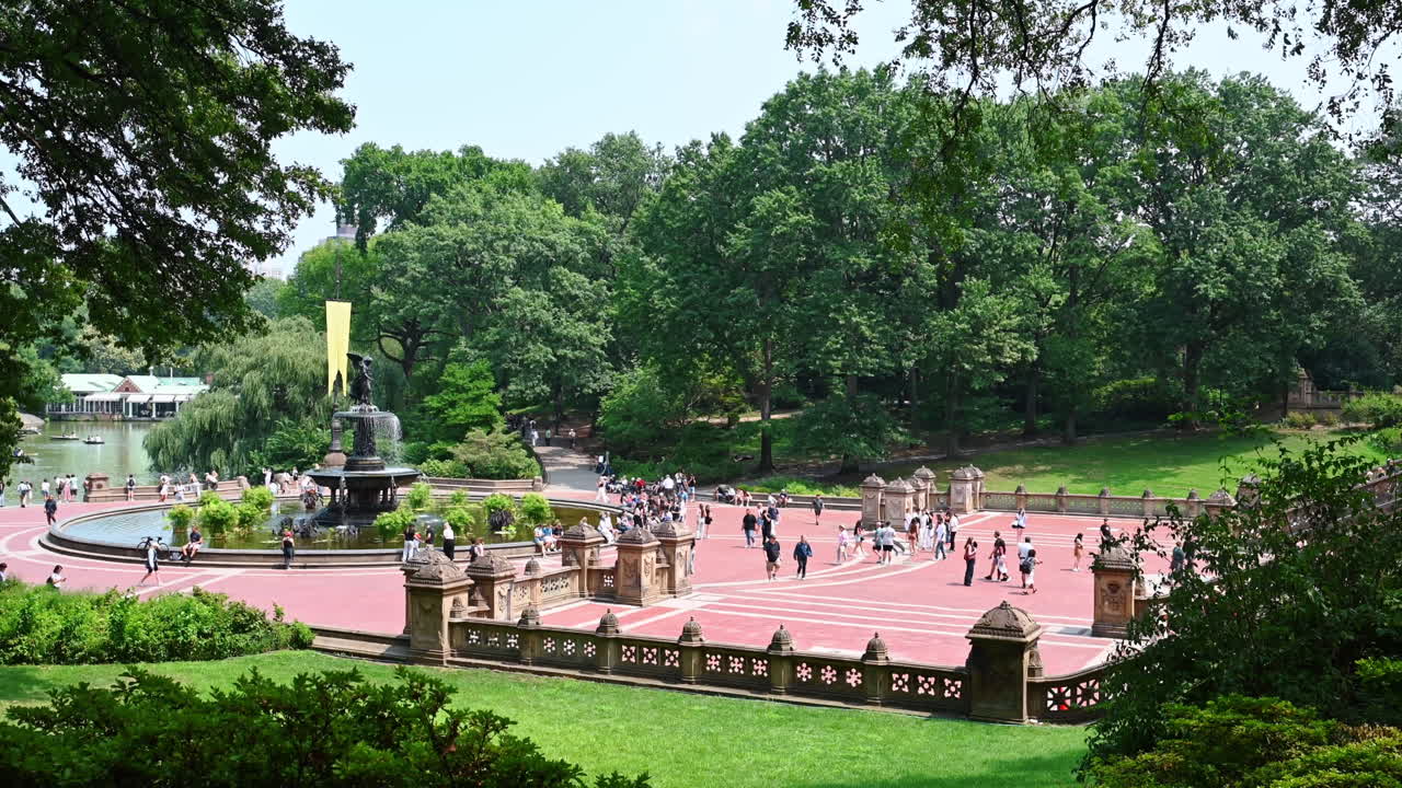 New York, Hoa Kỳ, ngày 8 tháng 7 năm 2025: Một ngày nắng đẹp tại Central Park ở New York, Hoa Kỳ. Nhiều người nghỉ ngơi và đi bộ gần đài phun nước Bethesda, xung quanh là cây xanh tươi tốt
