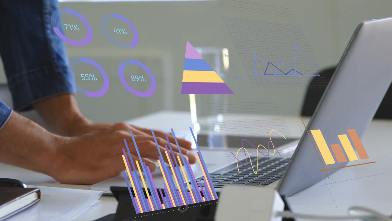 Male analyst typing and using trackpad, updating business bar charts, rings and line graphs