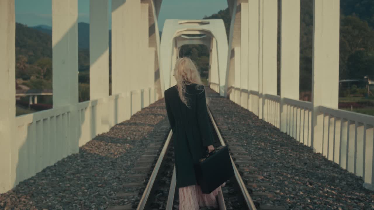 Woman Walking on a Bridge