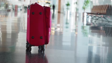 red suitcase at airport