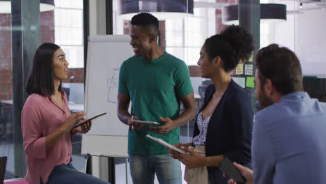 Mixed-race-business-colleagues-sitting-having-a-discussion-in-meeting-room