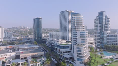 Umhlanga-coastal-skyline-with-modern-buildings,-clear-sky,-daytime,-aerial-view