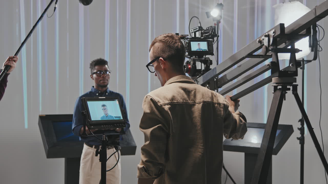 Operator With Camera Crane Shooting Video In Studio