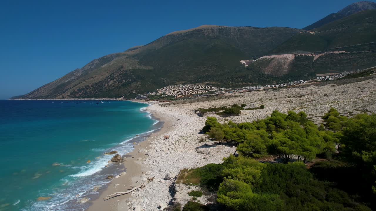 Pristine beaches and beautiful coastline in a bay on the Ionian Sea threatened by luxury resort constructions in Albania