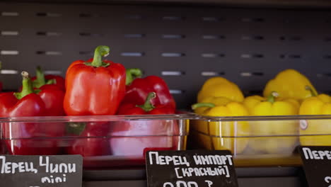 red and yellow bell peppers displayed at a grocery store