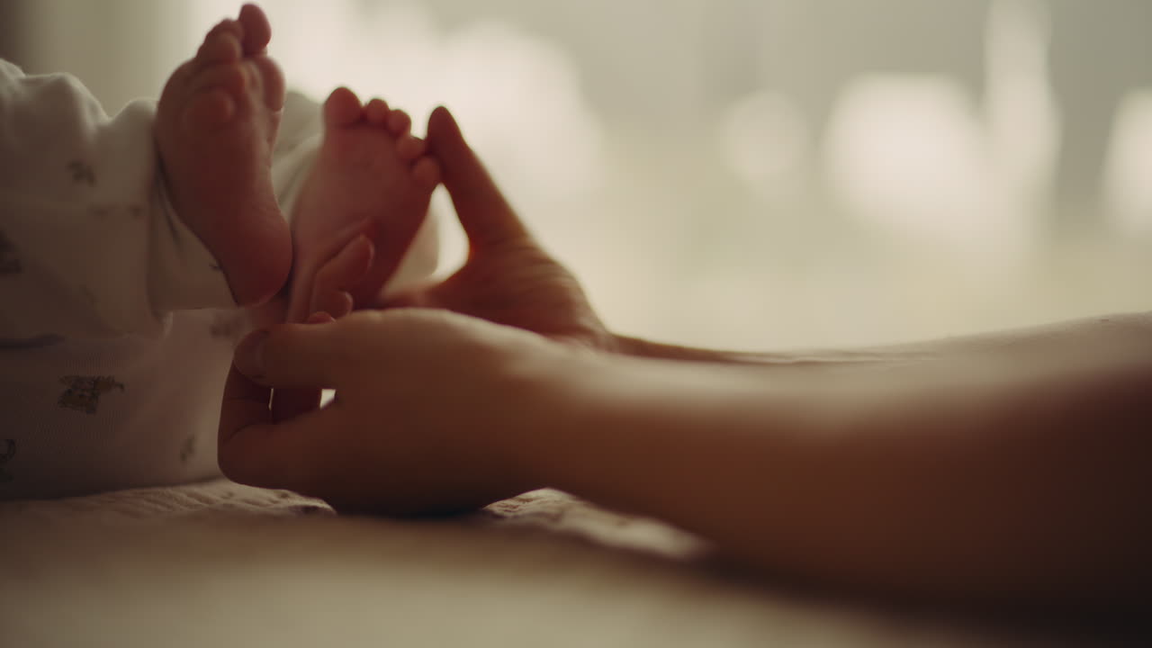 Newborn's Hand Touching Mother Symbolizes Motherhood