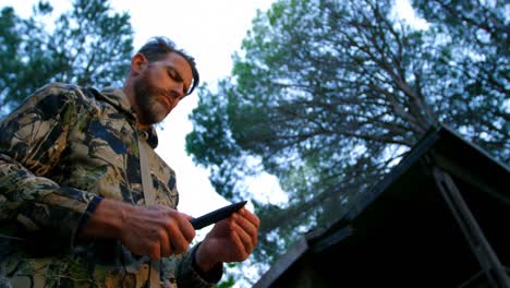 man holding hunter knife in the forest 4k