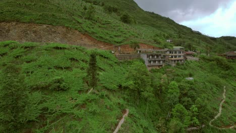 lush green mountain landscape with terraced fields and rural settlement