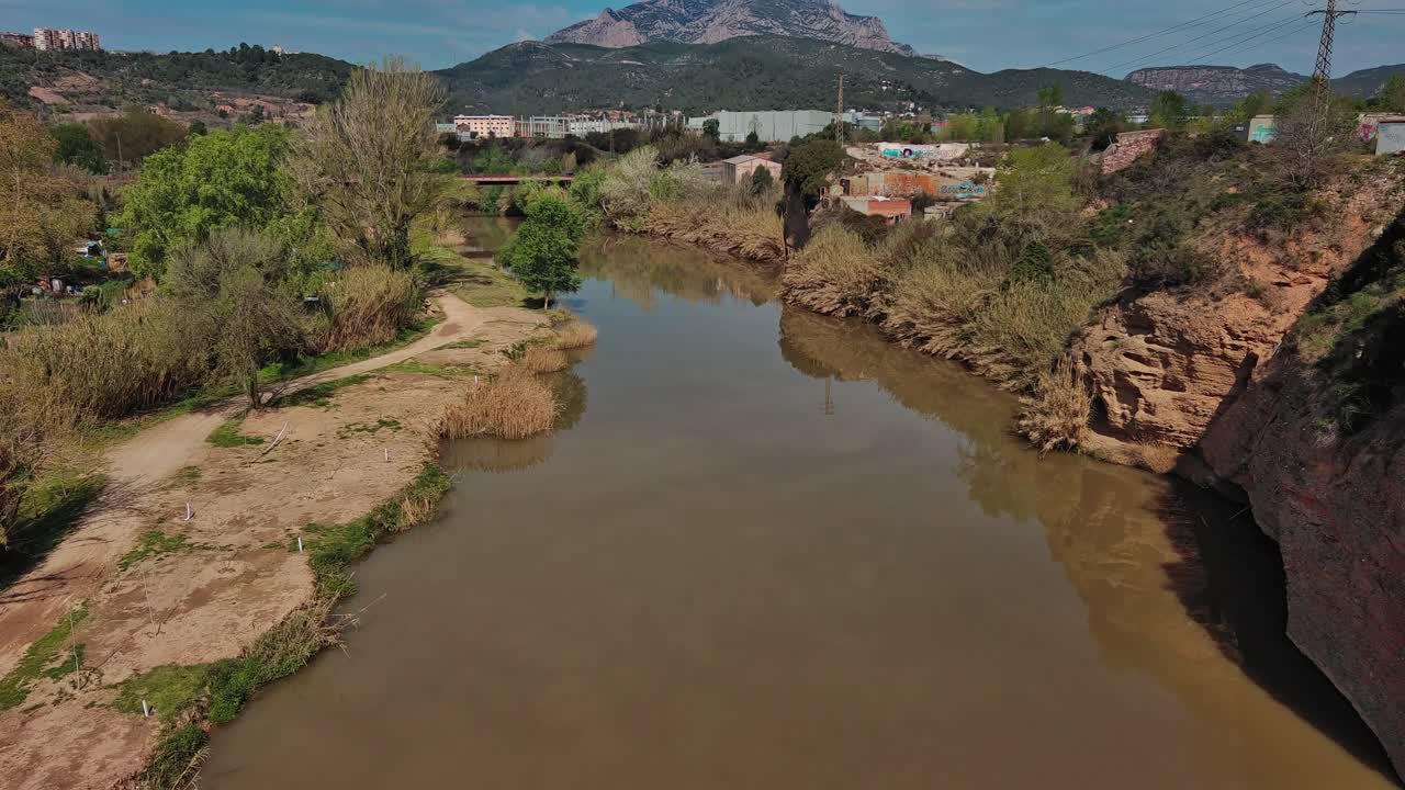 Aerial view of Llobregat river and reveal snowy mountain, Olesa de Montserrat