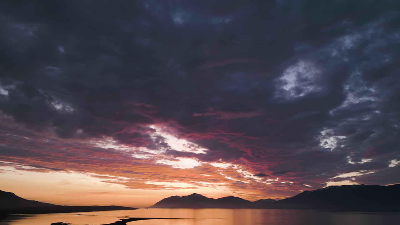 Golden hour in Iceland with mountains and a dramatic sky at sunset