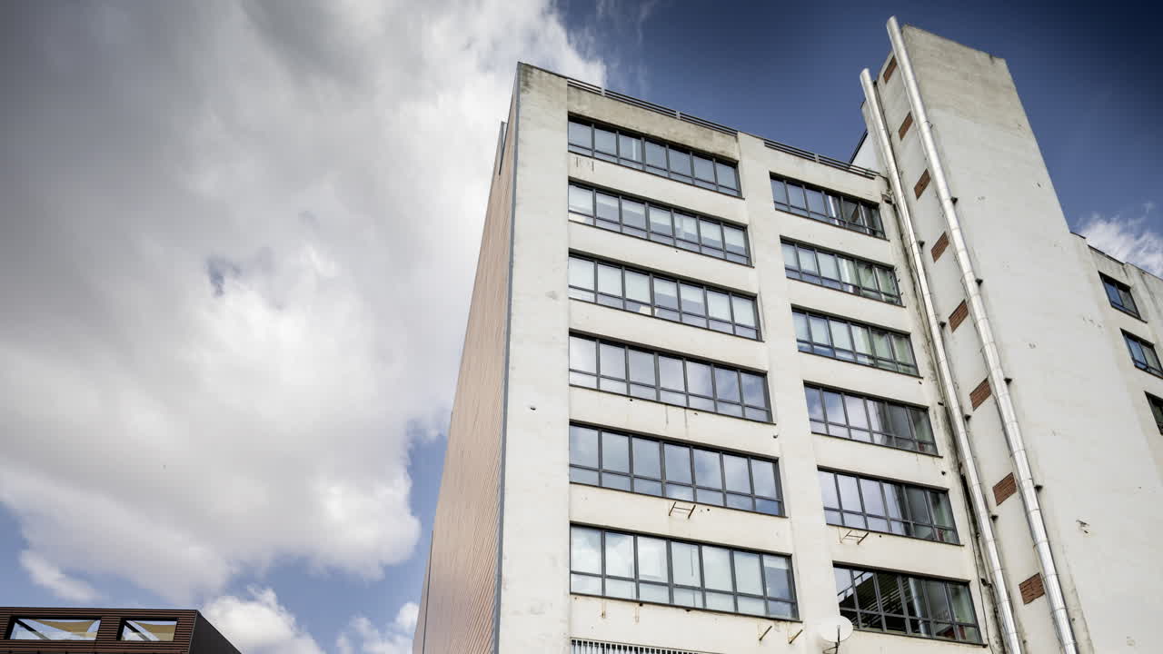 Old factory and industrial complex with passing clouds