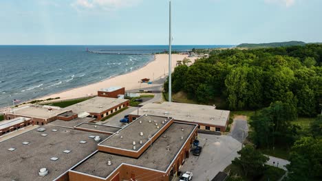 smooth drone descend to land over water treatment plant on lake michigan