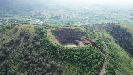 video showing a mountain with a hole at the top, where the crater is filled with water