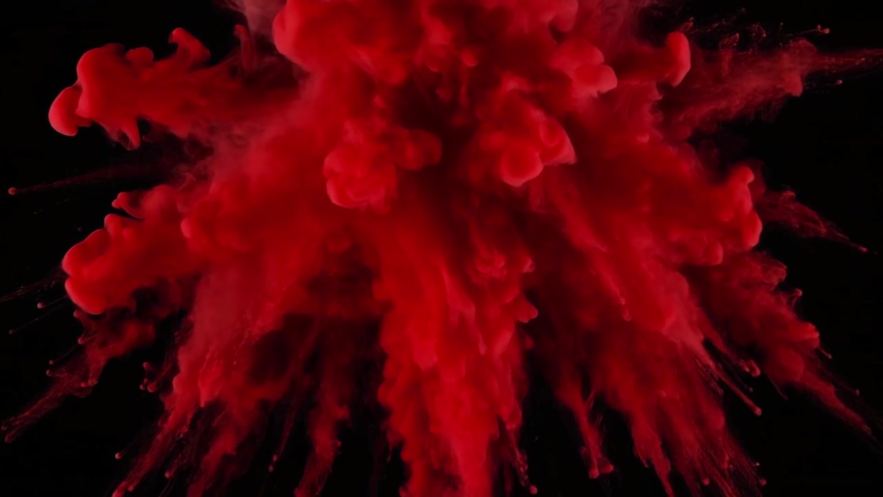 Explosion of Red Powder Against a Black Background