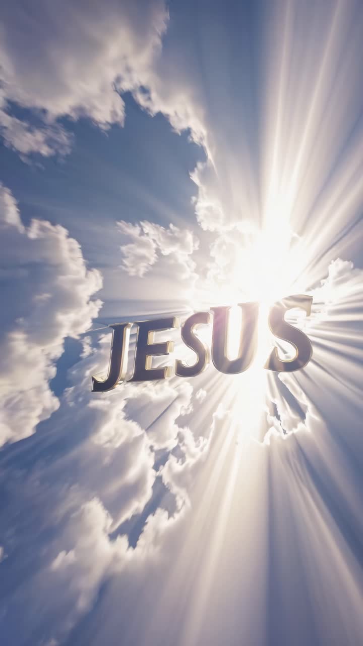 Dramatic upward angle captures 'Jesus' in bold letters emerging from radiant clouds