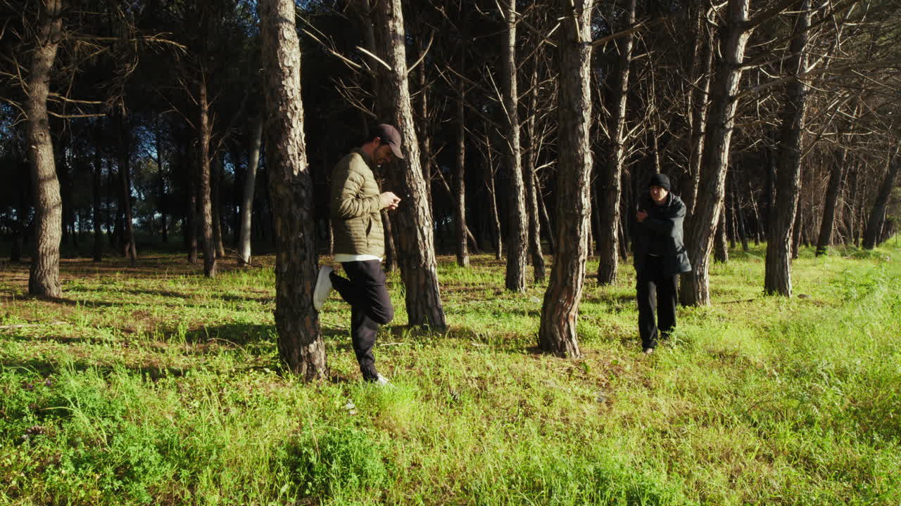Son Uses Phone and Father Observes Winter Forest During Holiday