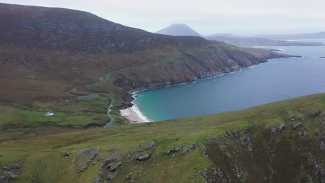 revealing cinematic drone shot of a small bay and keem beach, ireland on the wild atlantic way