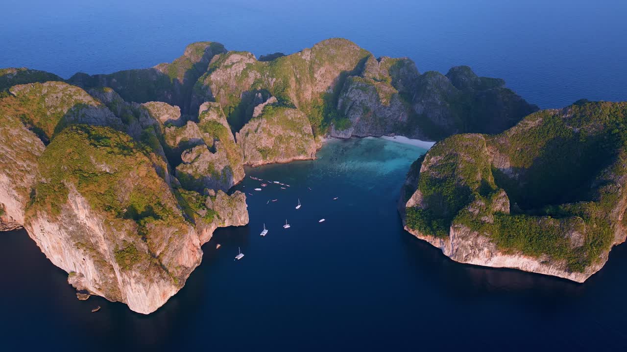Moving aerial shot capturing amazing view of The Maya Bay during morning in Thailand