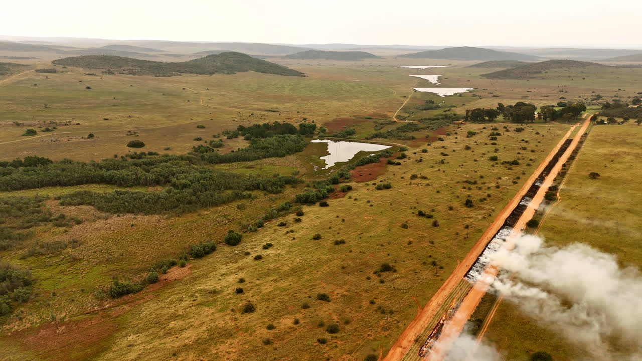 Smoke rise from where planned burns are effected creating firebreak, top aerial
