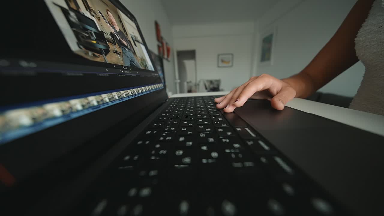 Person editing video on a laptop