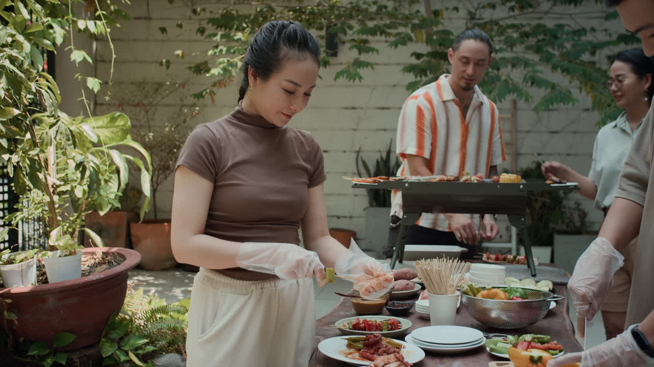 Portrait of Woman Cooking Skewer during Party with Friends