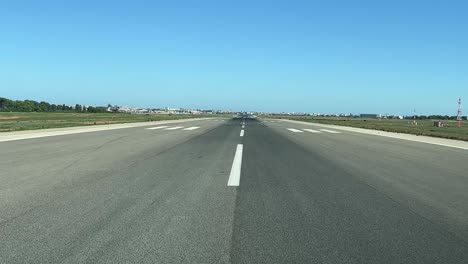 a pilot’s point of view preparing for take-off aligning in runway 12, in a splendid summer afternoon