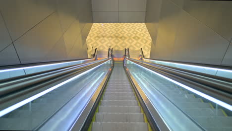 airport escalator going down, first person view