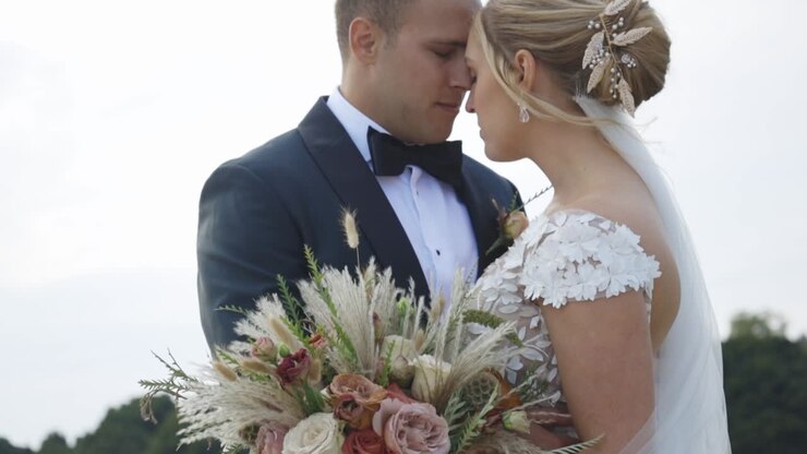Bride and groom rest foreheads together intimately