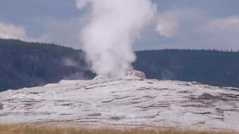 a close up view of old faithful geyser steaming in yellowstone national park