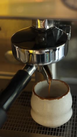 espresso machine pouring coffee into a small cup