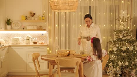 mother and daughter preparing for christmas celebration