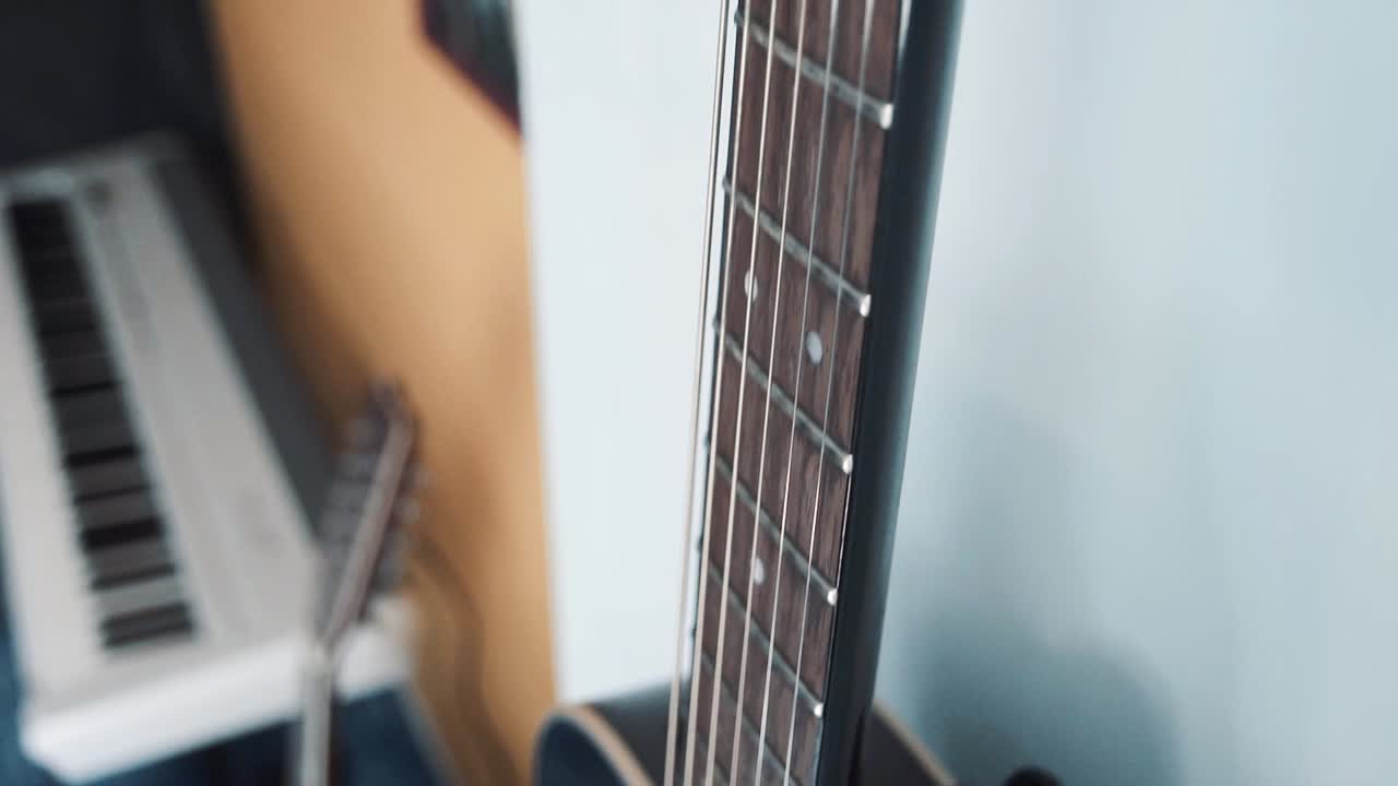 Guitar hanging on the wall in a bedroom
