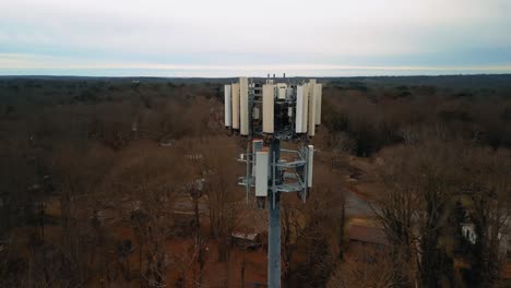 aerial shot rotating around cell phone tower in forest