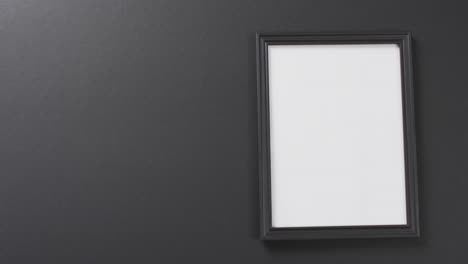 Video-of-black-wooden-frame-with-copy-space-on-grey-background