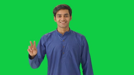 Happy-Indian-man-showing-victory-sign-Green-screen