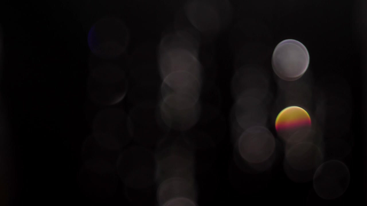 Colorful Iridescent Bokeh Circles on Black Background