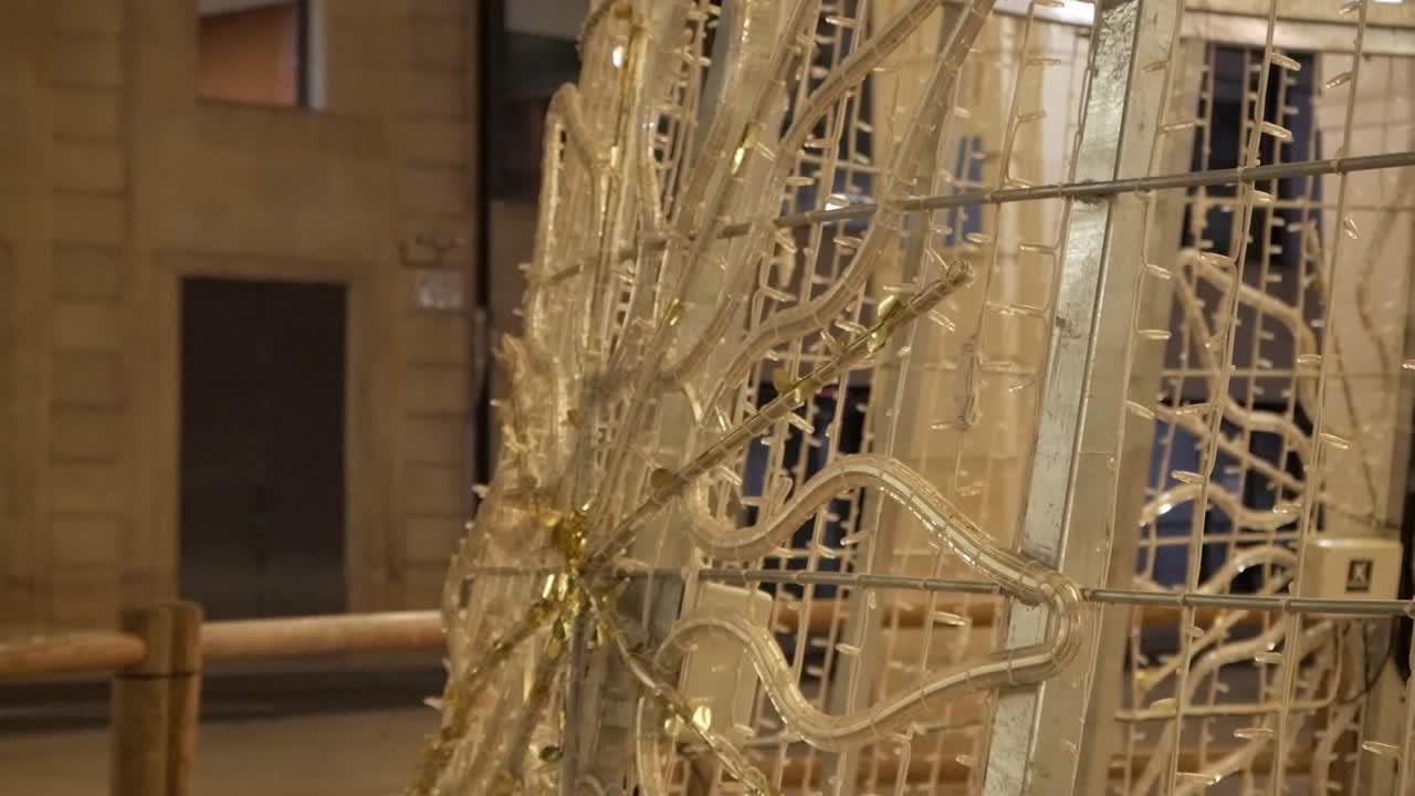 Festive holiday lights illuminate a decorative structure at night in Alicante, Spain