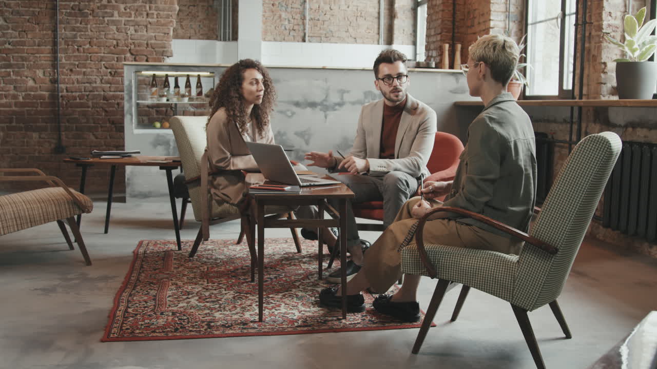 Business Partners Having Discussion in Modern Loft Coworking Space