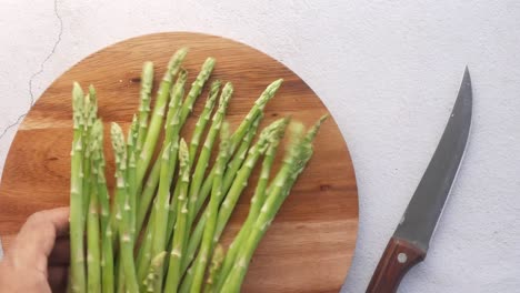 fresh asparagus on wooden board