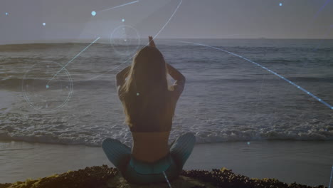 animation of networks of connections over caucasian woman praciticing yoga on beach