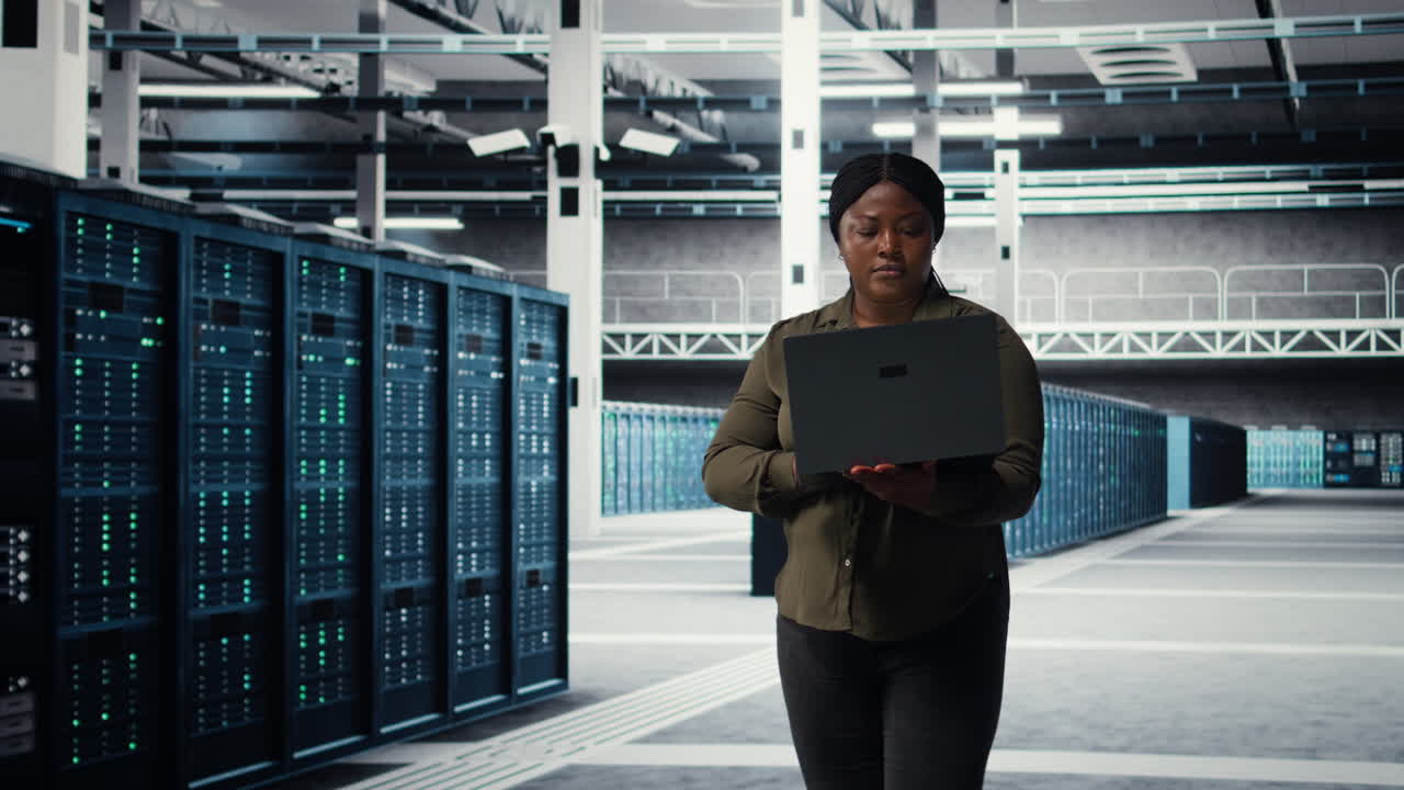 Data center engineer using laptop to develop disaster recovery plans