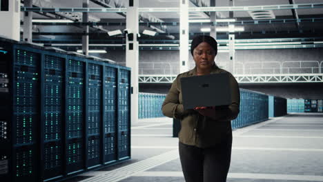 data center engineer using laptop to develop disaster recovery plans