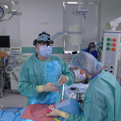 endonasal surgery in action. surgeon holds the equipment in the patient's nose. coming closer to the surgeon in protective uniform